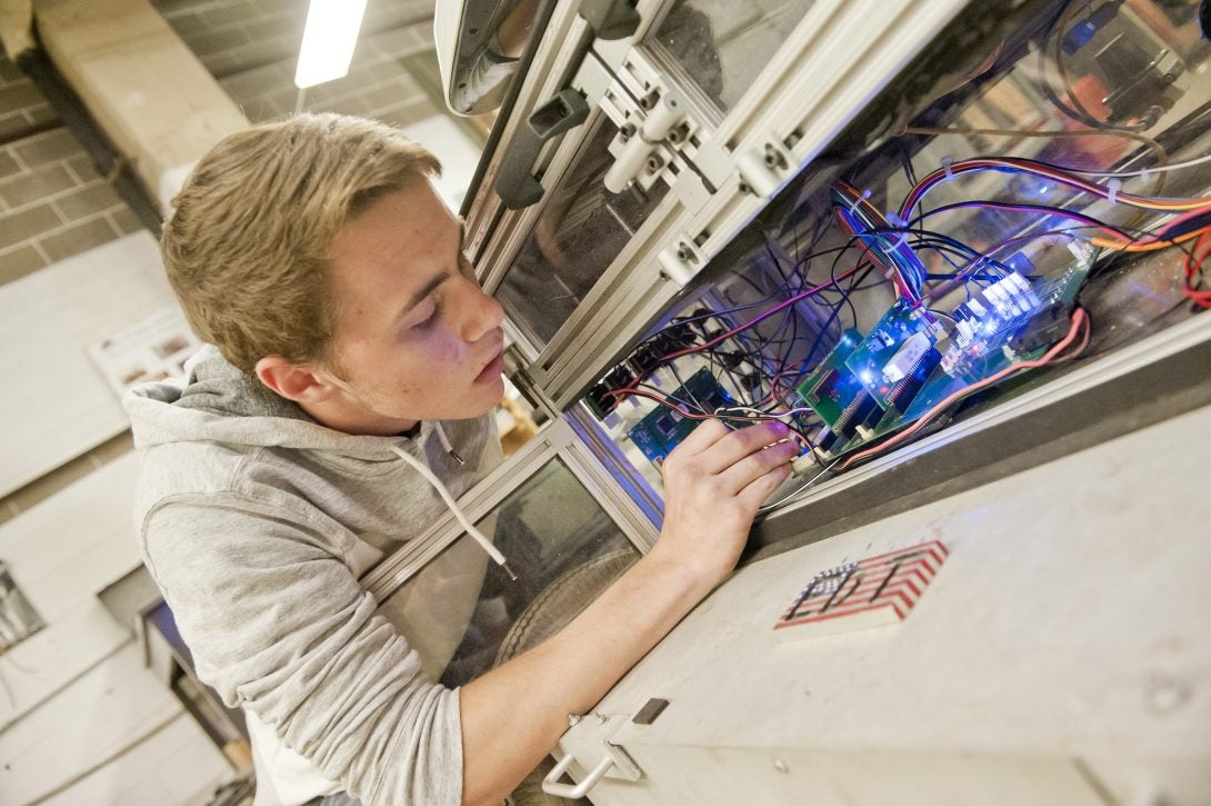 student working on EE project in lab