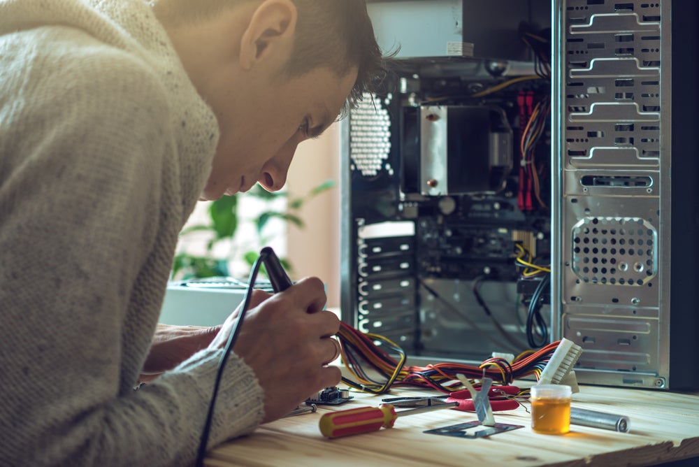 student working on a computer hardware assembly