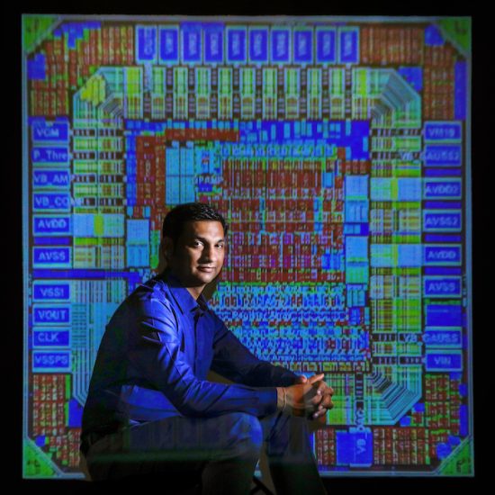 Amit Trivedi, assistant professor in ECE, with a projection of his computer chip design