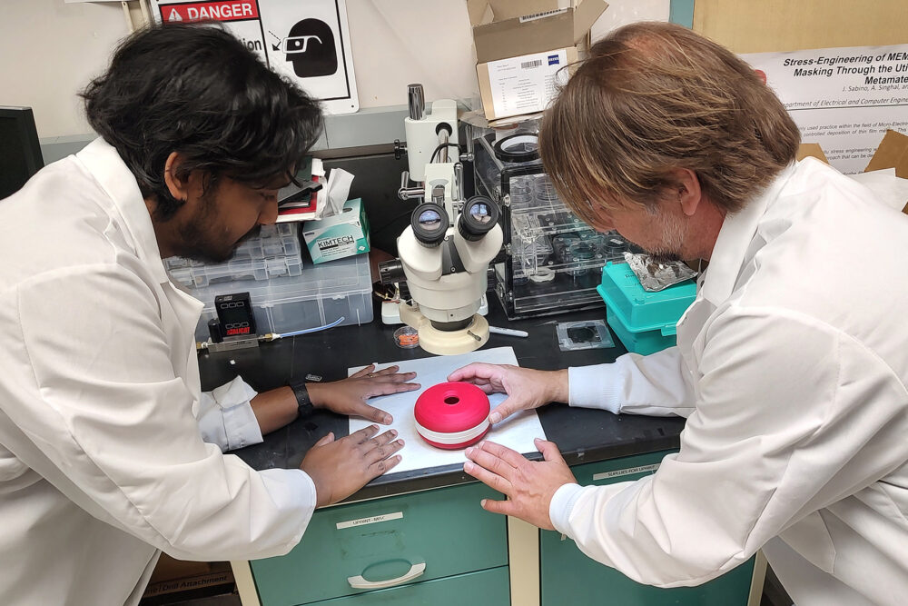 Nitin Jayakumar (left) and Igor Paprotny work on a prototype of their device for detecting airborne virus particles. (Photo courtesy Paprotny Lab/UIC.)