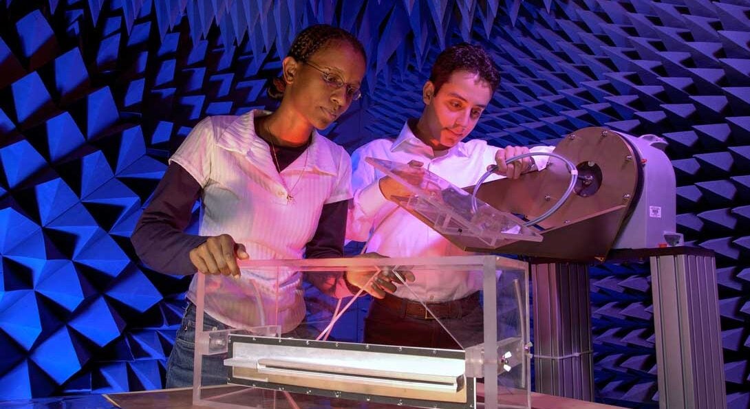 Two students working in the Anechoic chamber